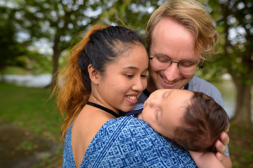 Fototapeta premium Multi-ethnic young family bonding together at the park
