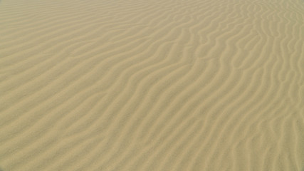 View of sand dune surface with undulated wave patterns former by wind, New Zealand