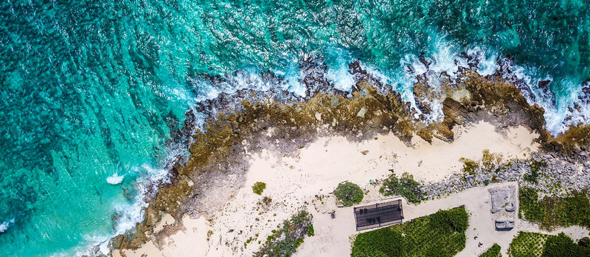 Drone shot of beautiful cost line and wave crunching on the stony beach 