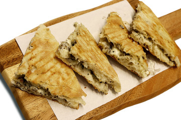 Top view Italian Pizza slice, mix whole wheat flour, with italian cream sauce inside, on wooden board, isolated on white background. Italian foods concept.