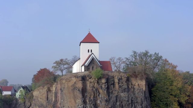 Church Overlooking a Small and Beautiful Lake on a Foggy Morning