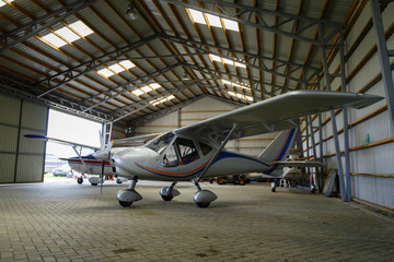 outdoor shot of small plane standing in shed