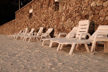 Fototapeta na wymiar Many white chair on the beach in evening time