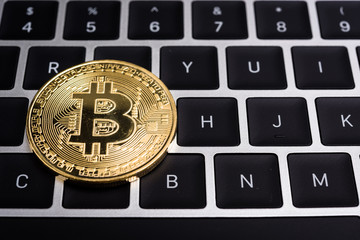 Coin, virtual golden bitcoin money on keyboard laptop computer, business electronic finance concept