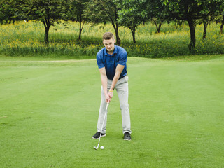 Happy golfer playing golf on green field, lifestyle concept.