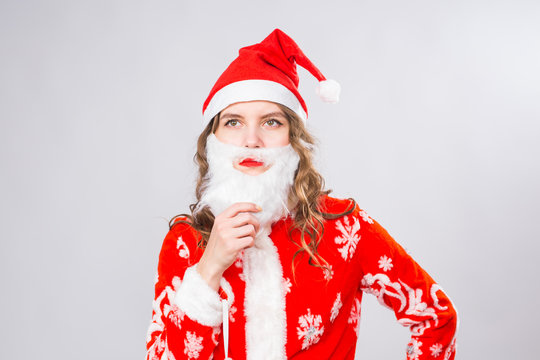 Christmas, Emotions And Joke Concept - Woman In Santa Costume With Fake Beard Look At You Seriously And Angrily On White Background With Copy Space