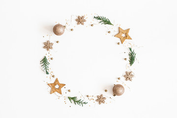 Christmas composition. Christmas wreath made of golden decorations, fir tree branches on white background. Flat lay, top view, copy space