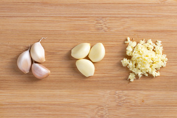 Garlic and garlic minced  on wooden plate Placed separately in groups. Top view