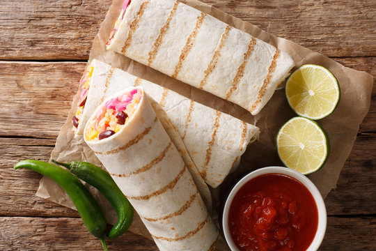 Dietary grilled vegetarian burrito with rice and vegetables close-up. Horizontal top view