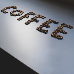 the word coffee written with coffee beans 