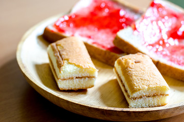 Bread with homemade jam on wooden table