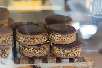 Chocolate alfajores, dulce de leche and mani stacked in showcase
