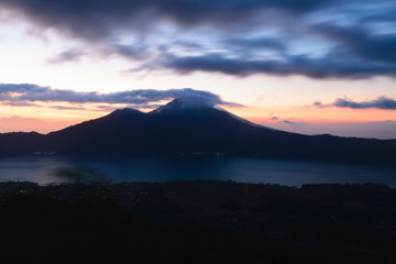 Fototapeta na wymiar Sunrise view from Gunung Batur volcano in Bali with visible Mount Agung volcano