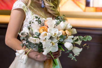 the bride is holding a wedding bouquet