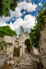 Springtime landscape of the ruins of Stari Bar ancient fortress, walking on arch way to ruined defense tower, in the medieval town of Bar in Montenegro