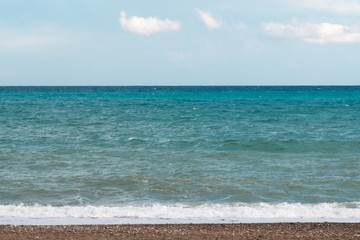 Fototapeta na wymiar Background. Turquoise sea and rocky beach