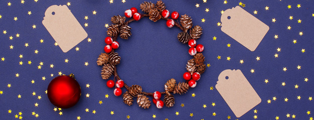 Christmas new year layout of wooden objects, sequins, decorative ornaments and a wreath of cones.banner