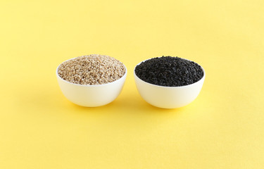 Healthy food white and black sesame seeds, rich in essential nutrients and high oil content, in bowls.