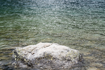 wet stone by lake shore
