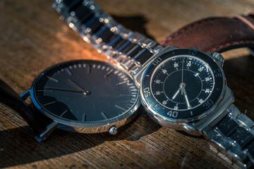 Two classic wrist watches on wood