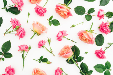 Floral pattern of roses flowers, petals and leaves isolated on white background. Flat lay, top view.