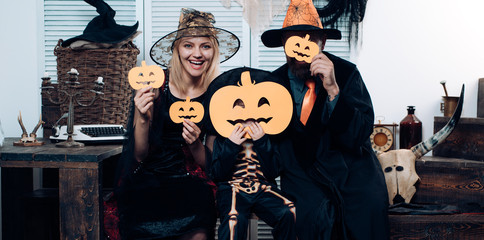 Happy family, mother, father and children in costumes and makeup on a celebration of Halloween. Family has fun in Halloween time. Trick or treat. Witch hat.