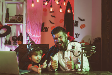 Happy family on Halloween. Father and son showing thumbs up. Autumn sale for black friday....