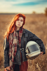 redhead girl in black leather jacket and helmet