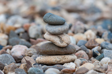 Small balancing stones sitting on other rocks