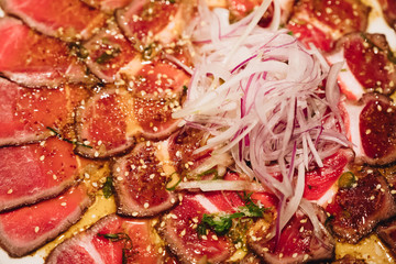 sliced raw meat, prepared Chinese-style, similar to the Japanese sushi