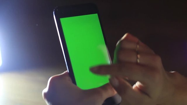 Women's hands use the phone with hroma-key.