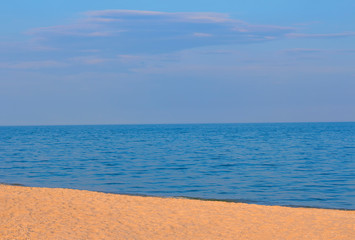 Fototapeta na wymiar sandy beach and calm sea water 