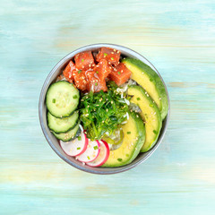 Hawaiian tuna poke salad on teal with copy space