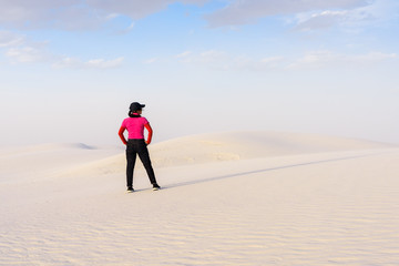 A woman hiking on  on beautiful sand desert, White Sands National Monument, New Mexico;