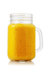 Smoothies made from ripe orange in glass jar isolated on white background