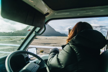 Woman taking photo of view in New Zealand