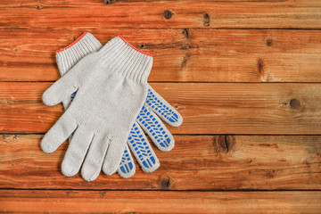 Work gloves on wooden background. Copy space.