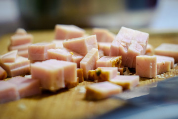 Cubes of bacon on wooden board