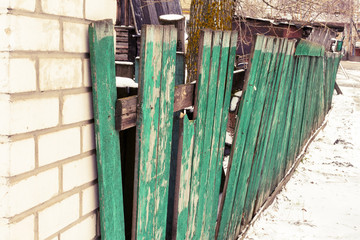 Old green wooden broken fence