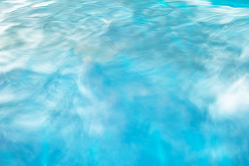 The smooth natural blue water background with bokeh  abstract on the sea or ocean,vintage and soft colored blur.