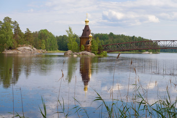 Landscape of the Vuoksa River with the wooden church of the Apostle Andrew the First Called....