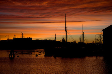 Boats and colorful clouds in the morning at the harbour of Stockholm
