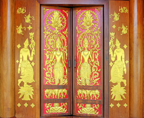 Traditional thai style carve on the wood door, temple of thailand.