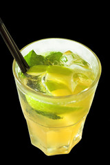 Summer refreshing drink with ice cubes, mint, lemon, apple. Isolated on black background. Top view