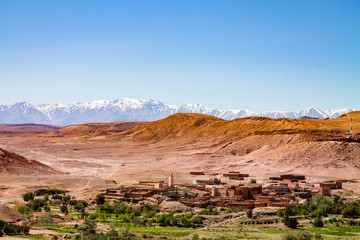 Traditional Berber city against the snowy Atlas Mountains. Africa Morocco Ait Ben Haddou