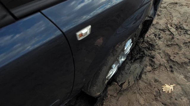 car stuck in the sand by the shore