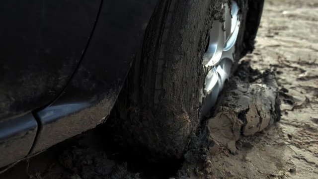 car stuck in the sand by the shore