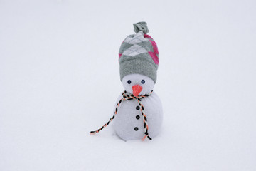  snowman handmade from cotton socks outside in the snow                            