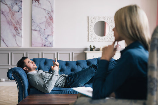 Unnerved Man Talking With Psychologist.