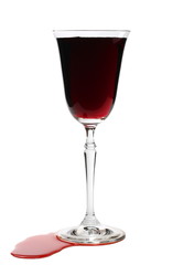 Red wine in glass and  puddle isolated on white background, clipping path